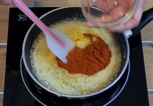 Add paprika to the butter.